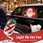 Festive projector beside a parked car with Santa design displayed on a window